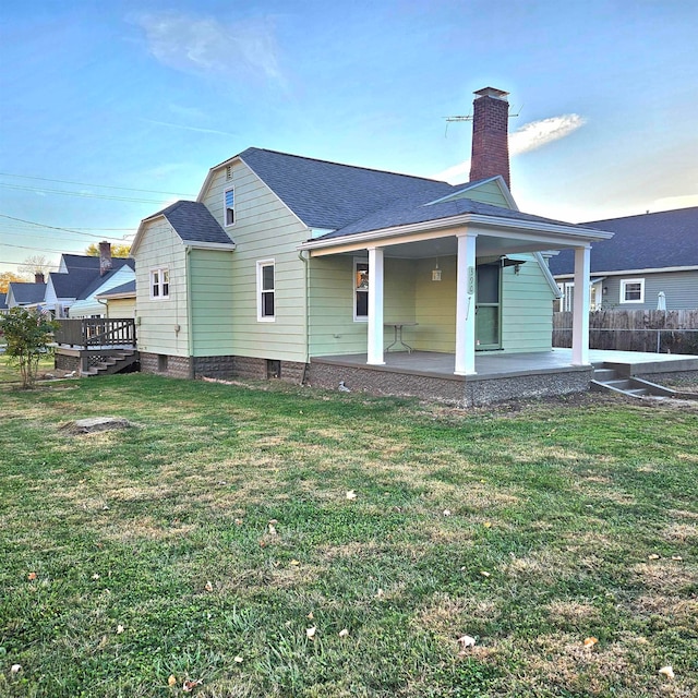 back of house with a yard and a patio area