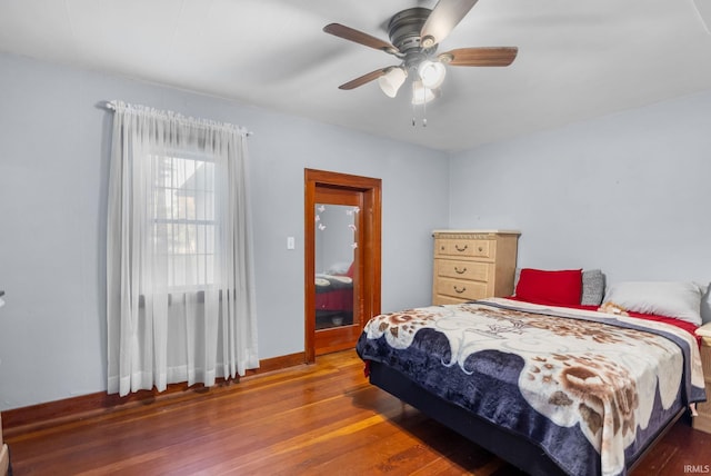 bedroom with wood-type flooring and ceiling fan