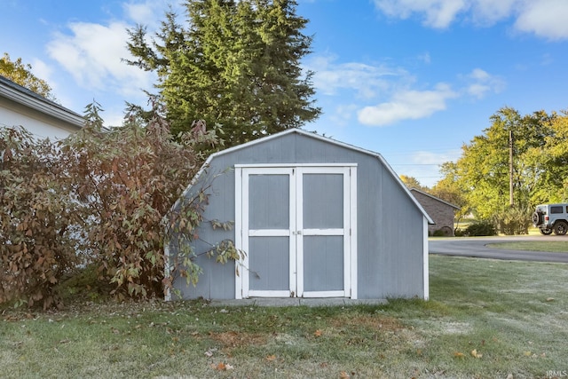 view of outbuilding with a yard