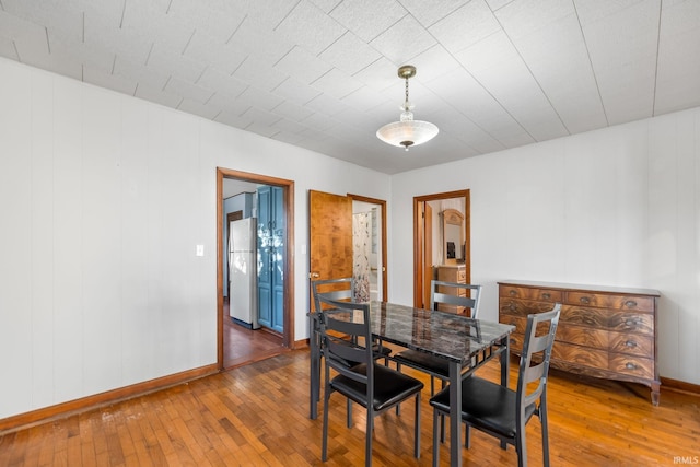 dining space with dark hardwood / wood-style flooring