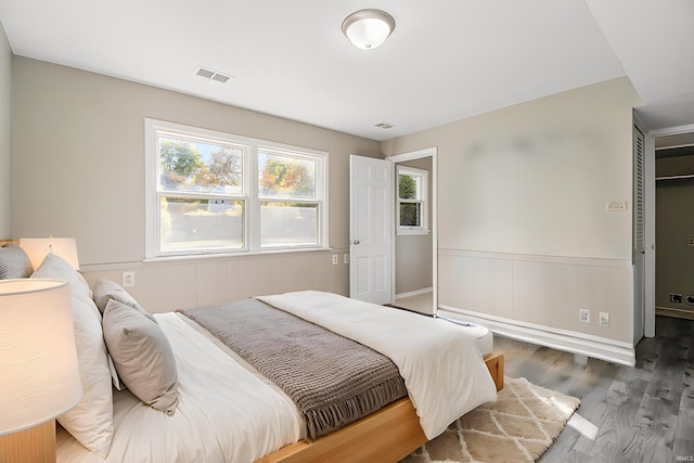 bedroom with dark hardwood / wood-style floors