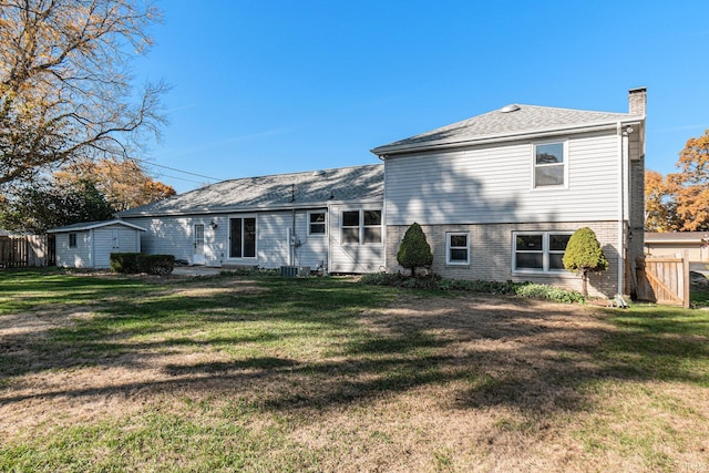 rear view of property with a lawn