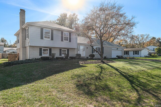 tri-level home with a front lawn and a garage