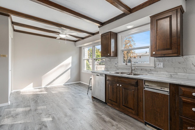 kitchen with beamed ceiling, stainless steel dishwasher, sink, and light hardwood / wood-style floors