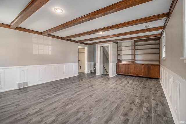 unfurnished living room with beam ceiling and hardwood / wood-style flooring