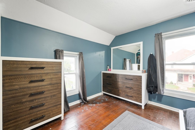 bedroom with vaulted ceiling and dark hardwood / wood-style flooring