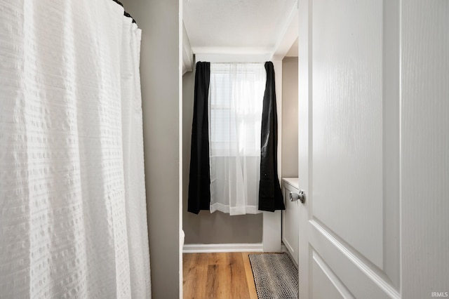 1316 S 19th St, New Castle, IN 47362 - bathroom with wood finished floors, baseboards, and a shower with curtain