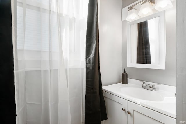 bathroom featuring vanity and curtained shower