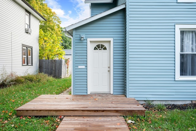 doorway to property with cooling unit and a deck