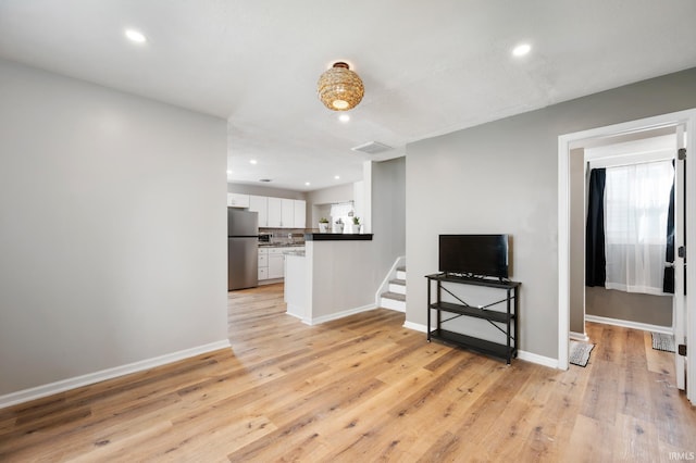 1316 S 19th St, New Castle, IN 47362 - living area with light wood-type flooring, recessed lighting, stairs, and baseboards