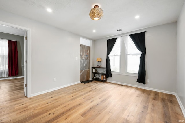 unfurnished room featuring light hardwood / wood-style flooring and plenty of natural light