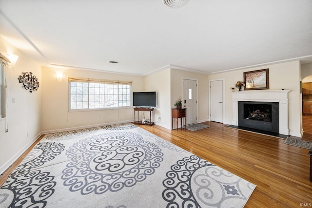 living room with hardwood / wood-style flooring and ornamental molding