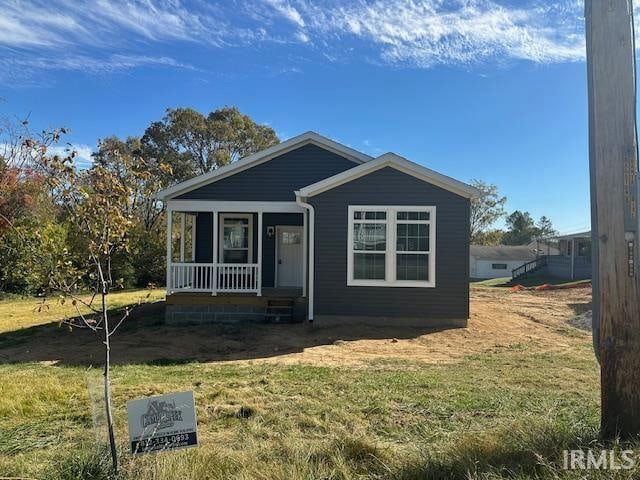 bungalow featuring a front lawn and a porch