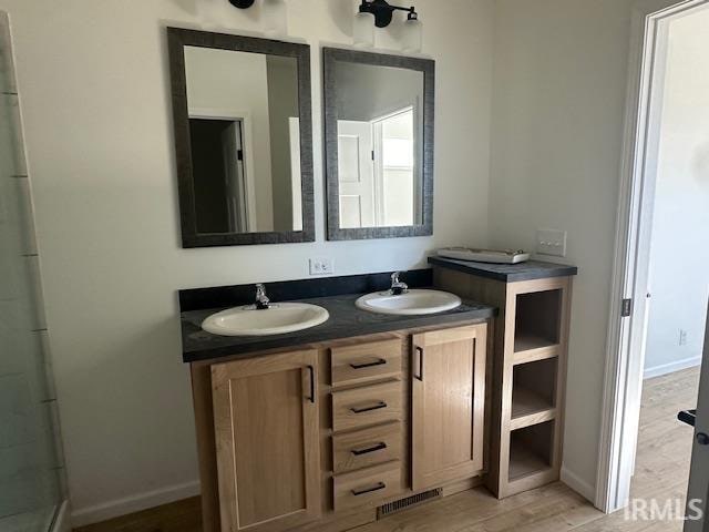 bathroom with vanity and hardwood / wood-style floors