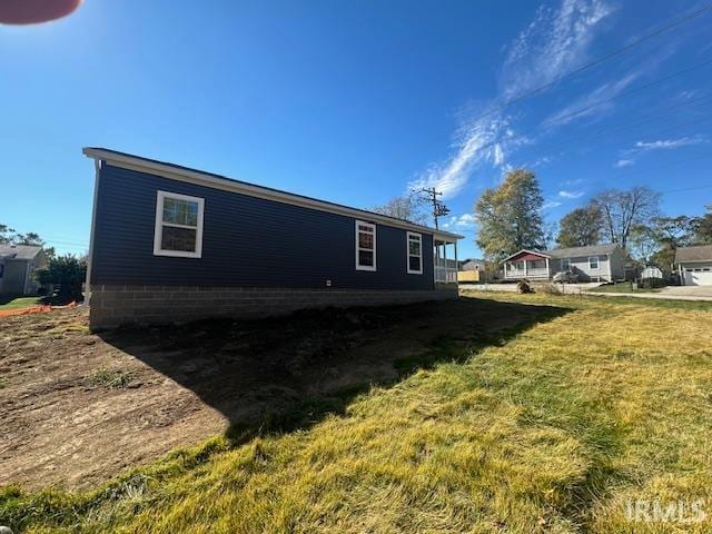 view of property exterior with a yard