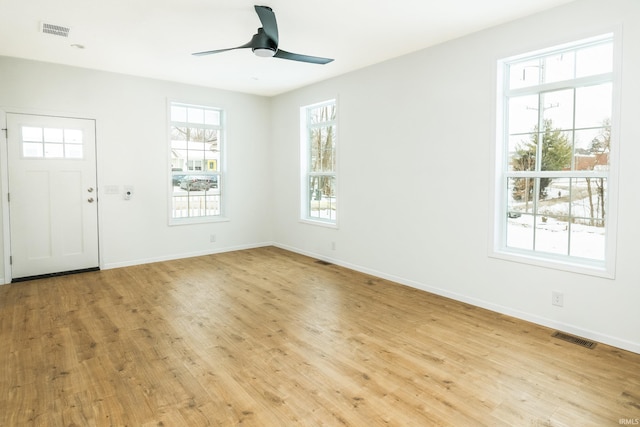 entryway with visible vents, ceiling fan, and wood finished floors
