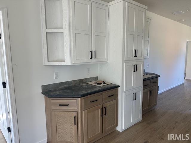 kitchen with light wood-type flooring and white cabinets