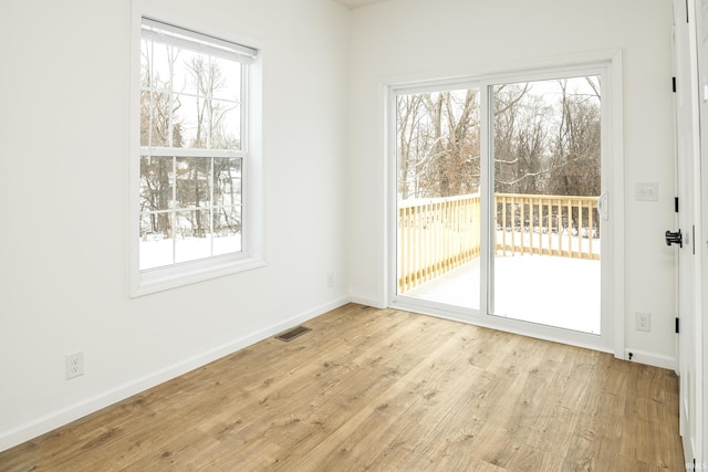 unfurnished dining area featuring baseboards, visible vents, and a healthy amount of sunlight