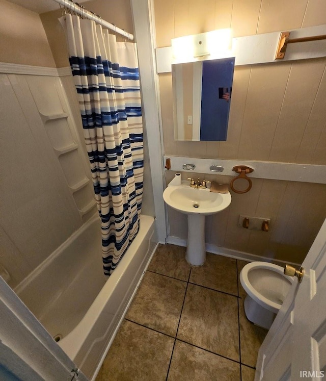 bathroom featuring shower / tub combo with curtain, toilet, and tile patterned floors