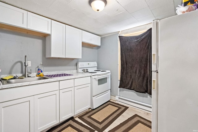 kitchen with white cabinetry, dark hardwood / wood-style flooring, sink, white appliances, and baseboard heating