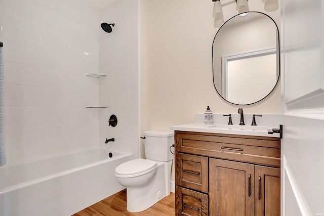 full bathroom featuring vanity, toilet, tiled shower / bath combo, and wood-type flooring