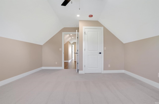 bonus room featuring light carpet, lofted ceiling, and ceiling fan