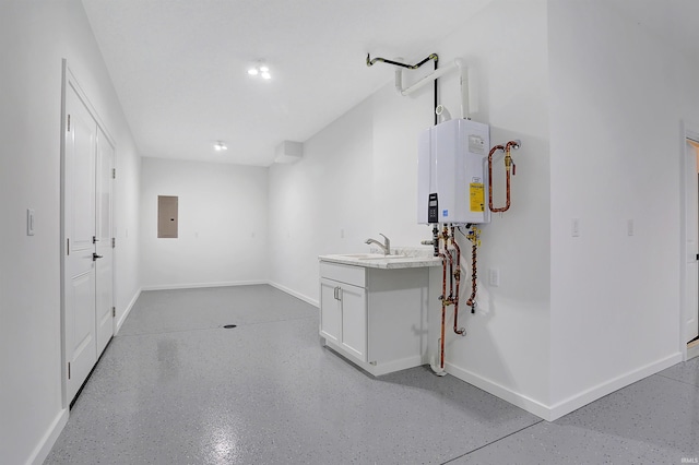 basement featuring sink, water heater, and electric panel