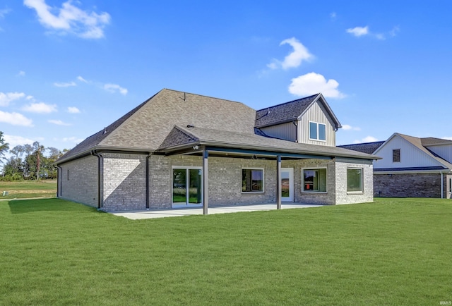 rear view of house featuring a patio area and a lawn