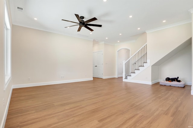 unfurnished living room with crown molding, light wood-type flooring, and ceiling fan