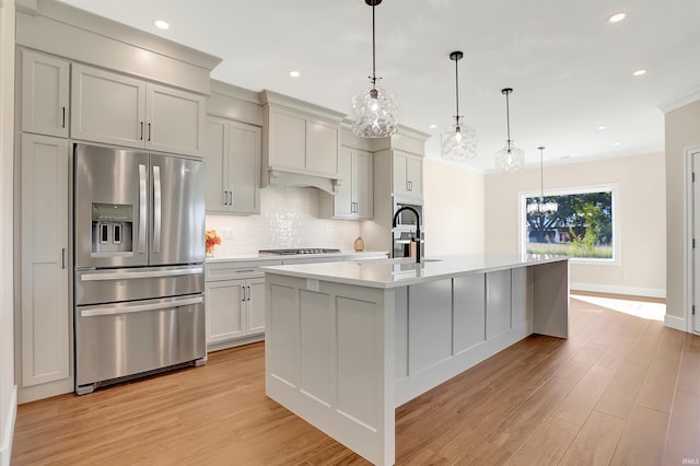 4711 Lemon Grass Ct, Evansville, IN 47725 - kitchen with a notable chandelier, stainless steel fridge, light countertops, gas stovetop, and tasteful backsplash