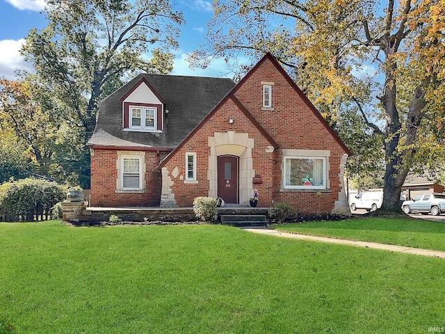 tudor-style house with a front yard