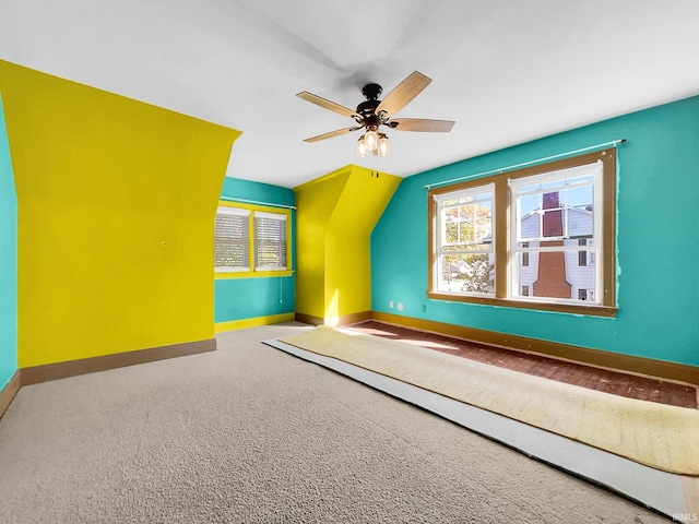 additional living space with carpet, vaulted ceiling, and ceiling fan