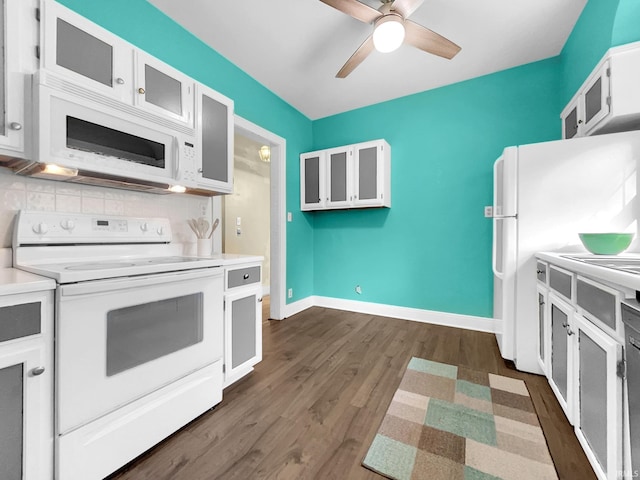 kitchen with white appliances, tasteful backsplash, white cabinetry, ceiling fan, and dark wood-type flooring