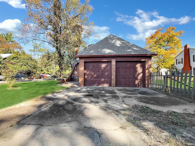 view of property exterior featuring an outbuilding, a yard, and a garage