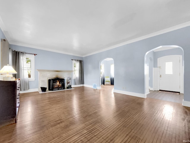 unfurnished living room featuring ornamental molding and hardwood / wood-style floors