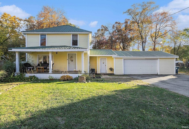 view of front of home with a front yard, a garage, and a porch