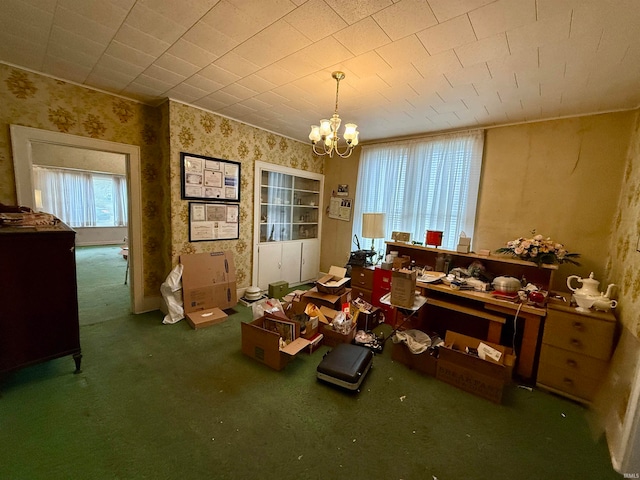 misc room with a chandelier and dark carpet