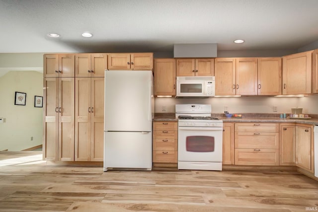 kitchen with a textured ceiling, light brown cabinetry, light wood-type flooring, and white appliances