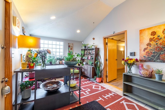 interior space featuring hardwood / wood-style flooring and vaulted ceiling