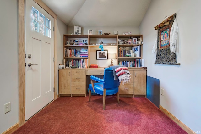 office space featuring dark carpet and vaulted ceiling