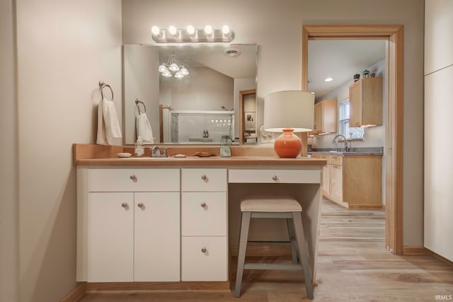 bathroom with vanity, hardwood / wood-style floors, and walk in shower