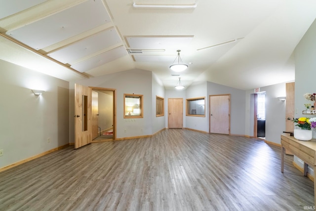 unfurnished living room with vaulted ceiling and hardwood / wood-style flooring