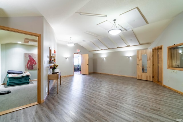 spare room featuring hardwood / wood-style floors and vaulted ceiling