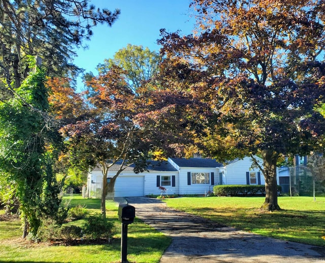 view of front of house featuring a garage and a front lawn