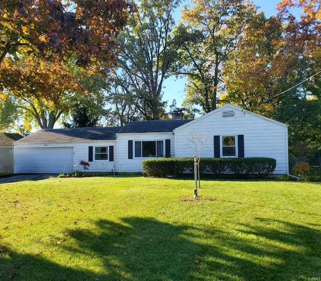 single story home featuring a garage and a front lawn