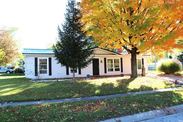 ranch-style house with a front lawn