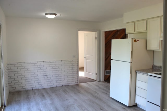 308 Clyde Ave, Angola, IN 46703 - kitchen featuring white appliances, white cabinetry, visible vents, and light wood-style flooring