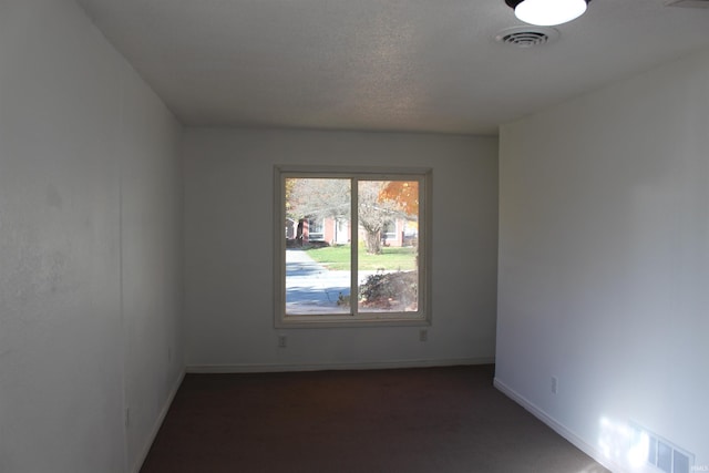 spare room featuring a textured ceiling