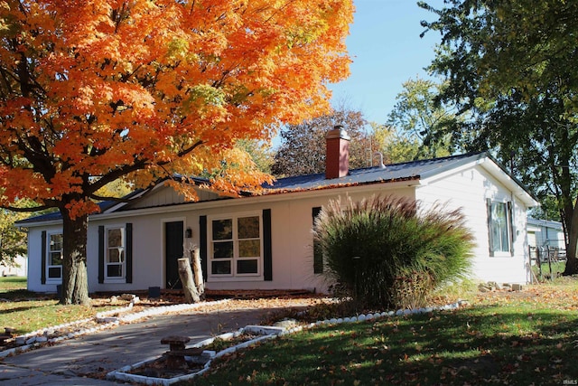 308 Clyde Ave, Angola, IN 46703 - ranch-style house featuring a chimney, metal roof, and a front yard
