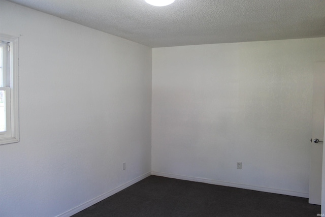 spare room featuring a textured ceiling